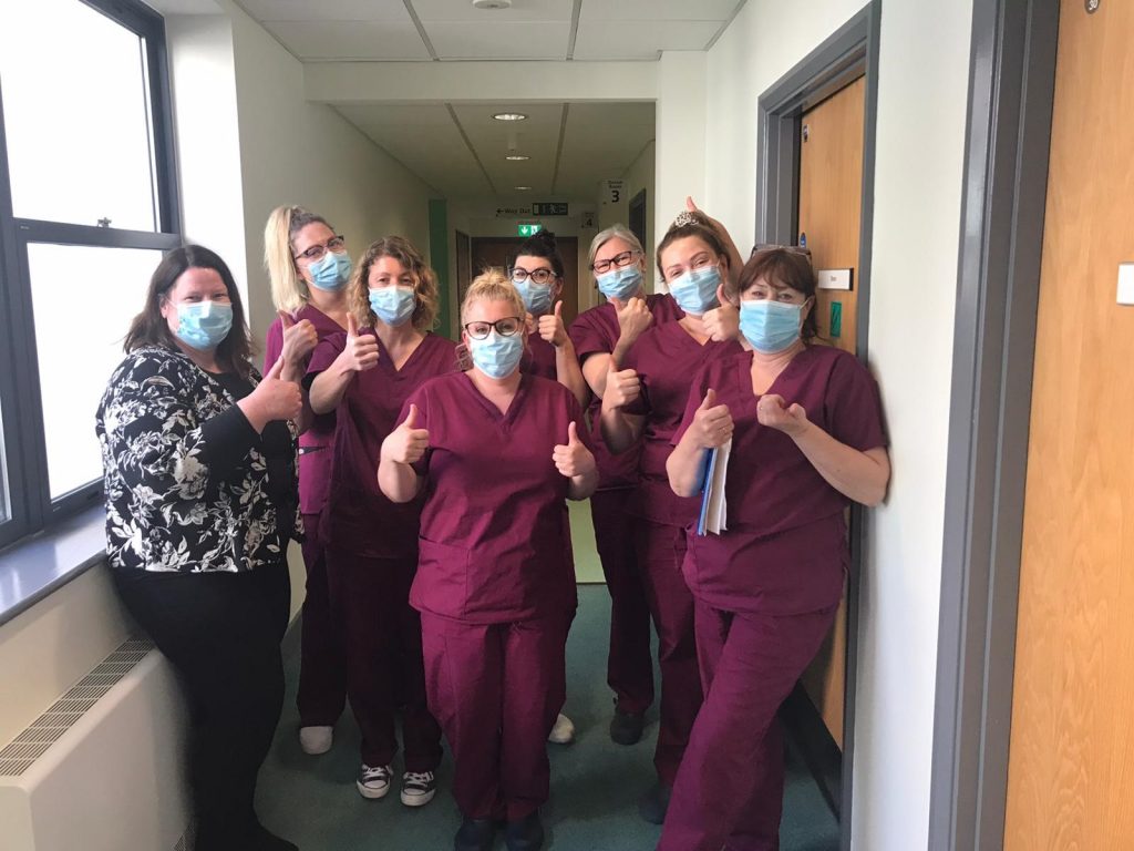 Dental team in clinic thumbs up
