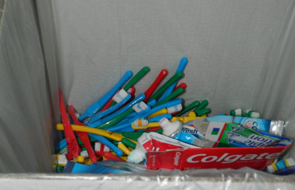 Colgate TerraCycle collection box containing old toothbrushes